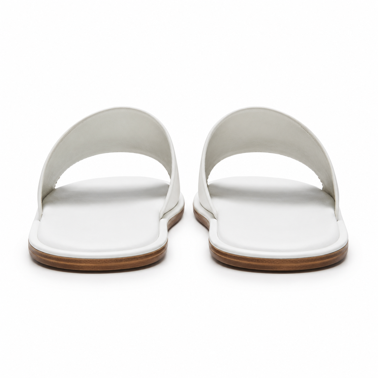 Rubber sole of white sandals for non-slip grip.