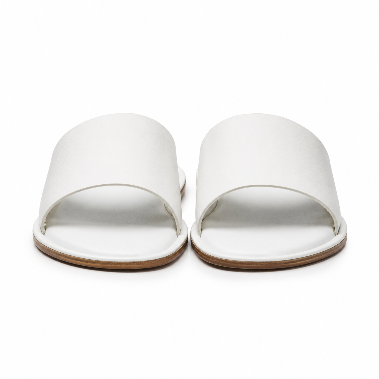 Front view of white leather slide sandals.