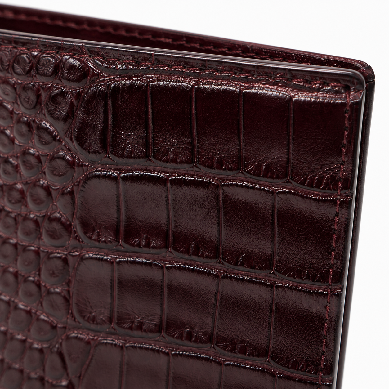 Burgundy leather wallet with elegant design.