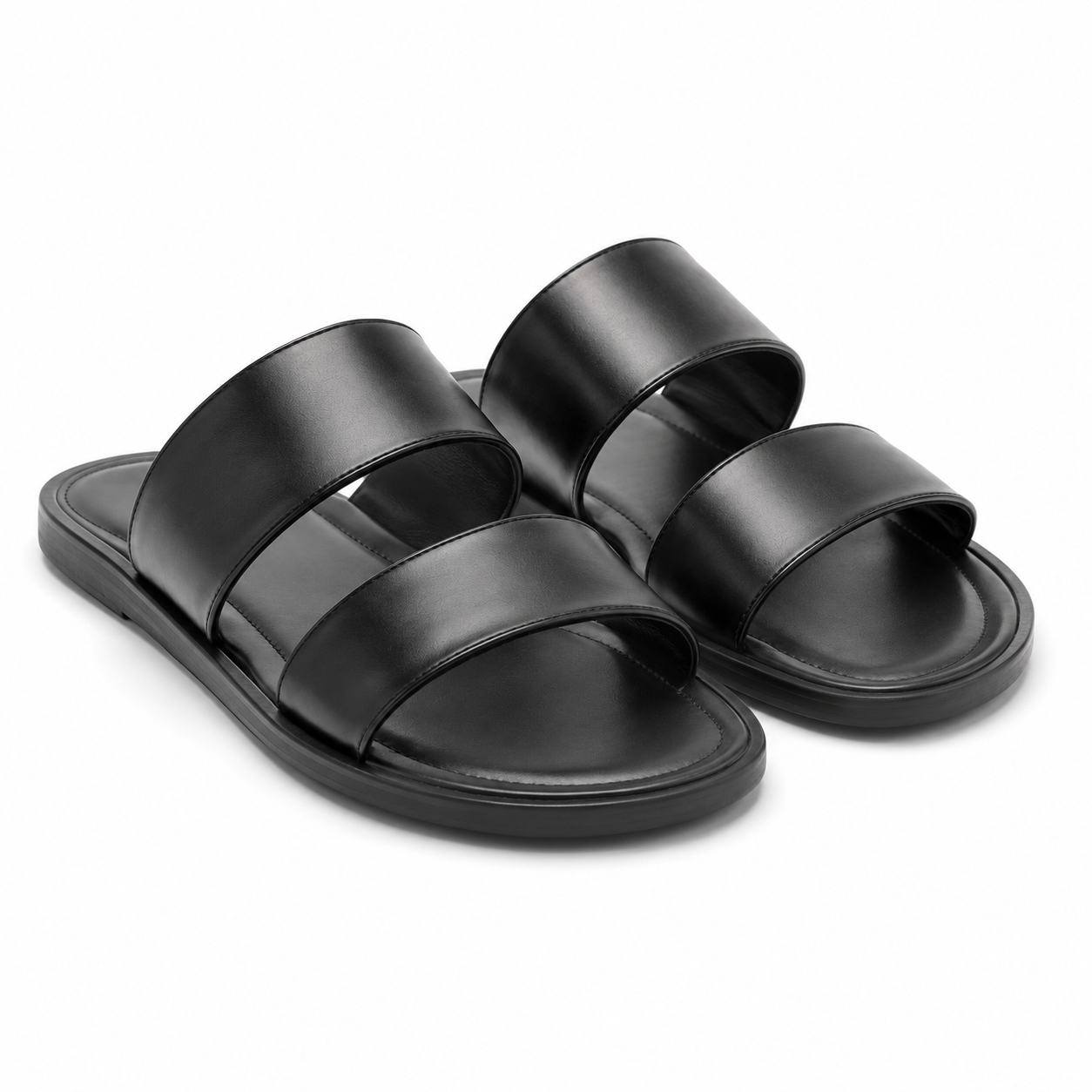 Side view of black leather sandals on a white background.