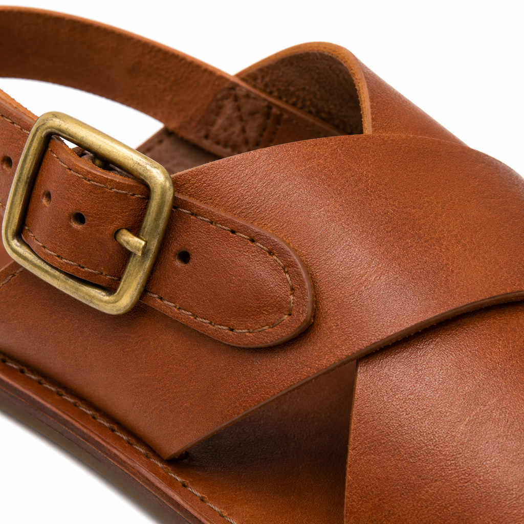 Detailed view of sole and stitching on leather sandals.