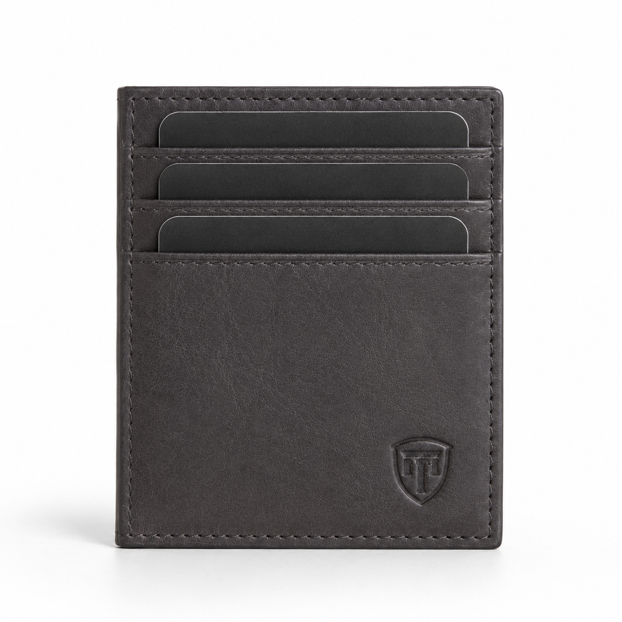 Close-up of embossed logo on leather passport holder.