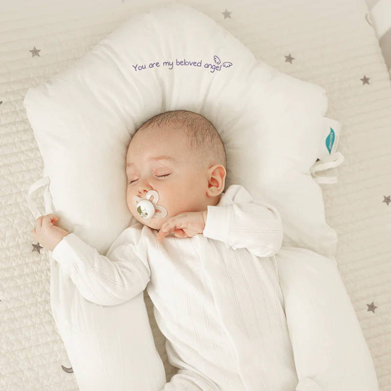 Close-up of the Modish-Vogue Baby Sleep Cushion showing the soft 100% cotton cover and ergonomic contours.