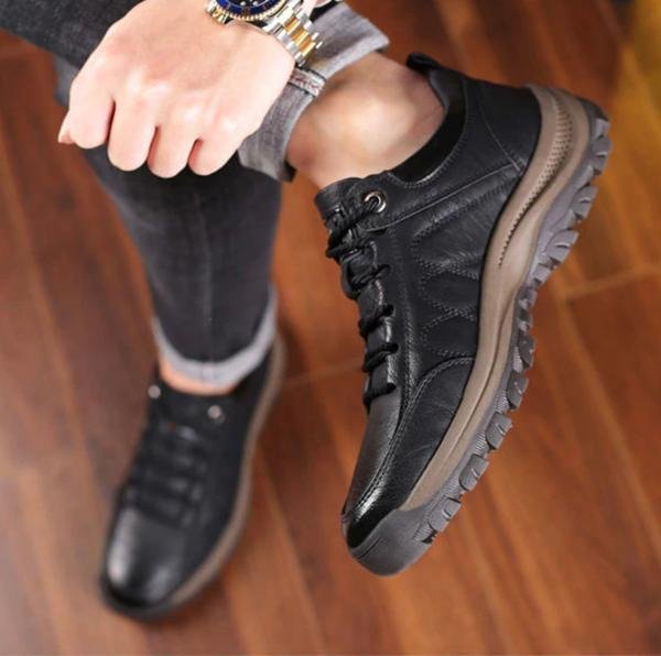 Men's orthopaedic leather boots worn outdoors, demonstrating waterproof capability and comfort