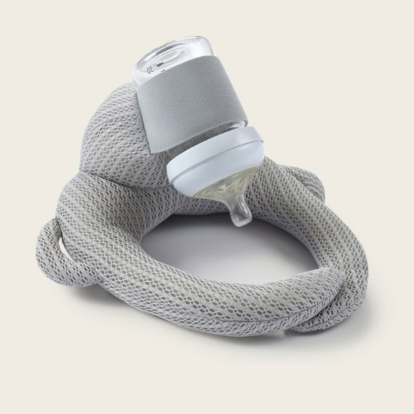 Baby Bottle Holder Pillow in orange velvet demonstrating proper feeding angle